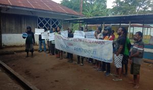 Sekelompok orang melakukan aksi demo dengan membentangkan spanduk – Surya Papua/IST