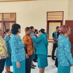 Ketua Tim Penggerak PKK Distrik Merauke, Ester Rudolf Corputty sedang menyematkan lambang kepada salah seorang pengurus – Surya Papua/Ichal Ukat
