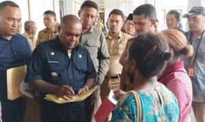 Bupati Merauke, Romanus Mbaraka sedang melayani salah seorang warga usai membuka bimtek – Surya Papua/Frans Kobun
