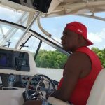 Bupati Merauke, Romanus Mbaraka sedang melihat-lihat gelombang saat mengendalikan setir speedboat – Surya Papua/Frans Kobun