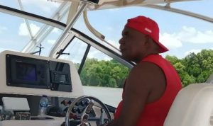 Bupati Merauke, Romanus Mbaraka sedang melihat-lihat gelombang saat mengendalikan setir speedboat – Surya Papua/Frans Kobun