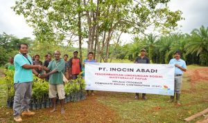 Foto bersama masyarakat dengan pihak perusahan saat pemberian bantuan bibit pohon – Surya Papua/IST