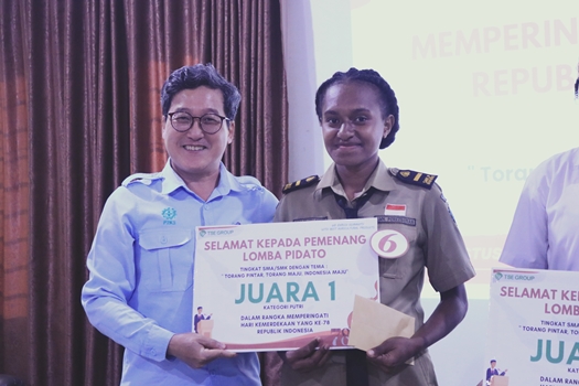 General Manager PPA MGT,  Mr. Park Jibae sedang menyerahkan bantuan kepada seorang siswi yang juara – Surya Papua/IST