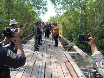 Bupati Merauke, Romanus Mbaraka saat meninjau jembatan kayu yang merupakan penghubung ke Batu Merah- Surya Papua/Frans Kobun