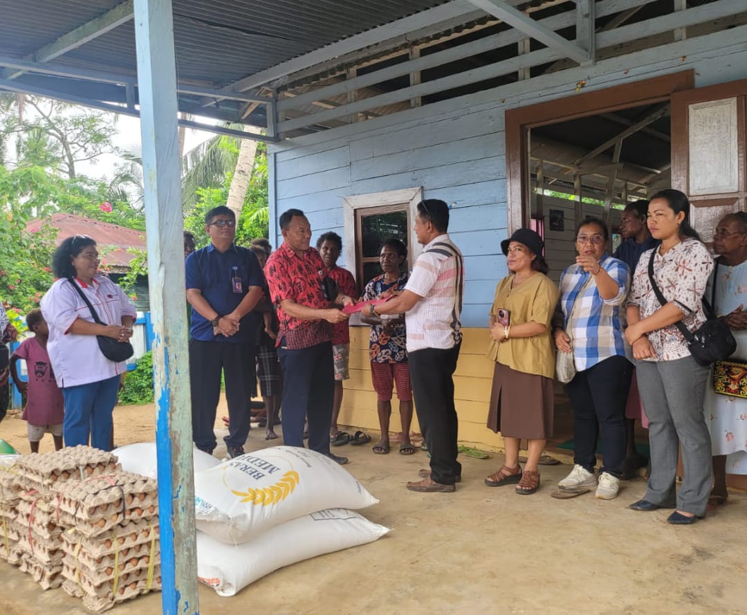 Penyerahan bantuan oleh Ketua Perumnas Aviasi Kabupaten Merauke, Blasius Basa kepada umat Yobar yang diterima Ketua DPP Paroki Santa Theresia Buti, Izaak Layaan – Surya Papua/IST