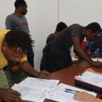 Para tersangka sedang menandatangani berita acara saat di Kejari Merauke – Surya Papua/IST