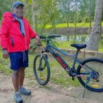 Mantan Bupati Merauke, Romanus Mbaraka saat bersepeda di kebunnya di Kampung Sarsang – Surya Papua/IST