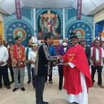 Ketua HKT Merauke, Theo Fatruan sedang menyerahkan bantuan dana senilai Rp30 juta kepada Pastor Paroki Santa Theresia Buti, Simon Petrus Matruty – Surya Papua/Frans Kobun