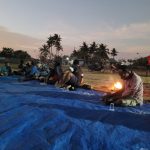 Masyarakat Marind Imbuti sebagai pemilik negeri ini sedang duduk bersama di lokasi pembangunan Gereja Santa Theresia Buti di bagian belakang – Surya Papua/IST