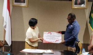Penyerahan plakat oleh Asisten II Setda Merauke, Martha Bayu kepada Bupati Merauke, Yoseph Bladib Gebze – Surya Papua/Frans Kobun